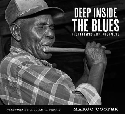Cover art for Deep Inside the Blues by Margo Cooper. A black and white photograph of a middle aged Black man in a plaid flannel shirt and a worn baseball cap, focused entirely on playing a wind instrument. His eyes are closed with emotion. The pipe looks to be a variety of wooden flute.