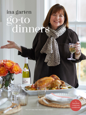 cover of "go-to dinner" by Ina Garten which features a picture of the author standing by a turkey dinner holding a glass of wine