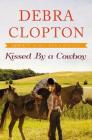Kissed by a Cowboy (Four of Hearts Ranch Romance #3) By Debra Clopton Cover Image