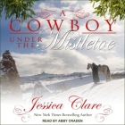 A Cowboy Under the Mistletoe Lib/E By Jessica Clare, Abby Craden (Read by) Cover Image