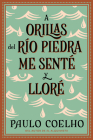 By the River Piedra I Sat Down and Wept: A Orillas del Río Piedra me senté y lloré / (Spanish edition) By Paulo Coelho Cover Image